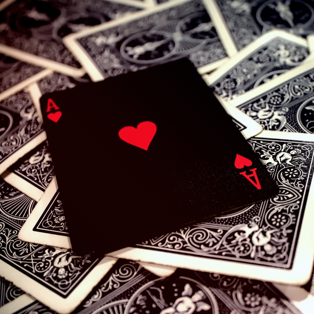 Ace of hearts lies on a deck of cards
