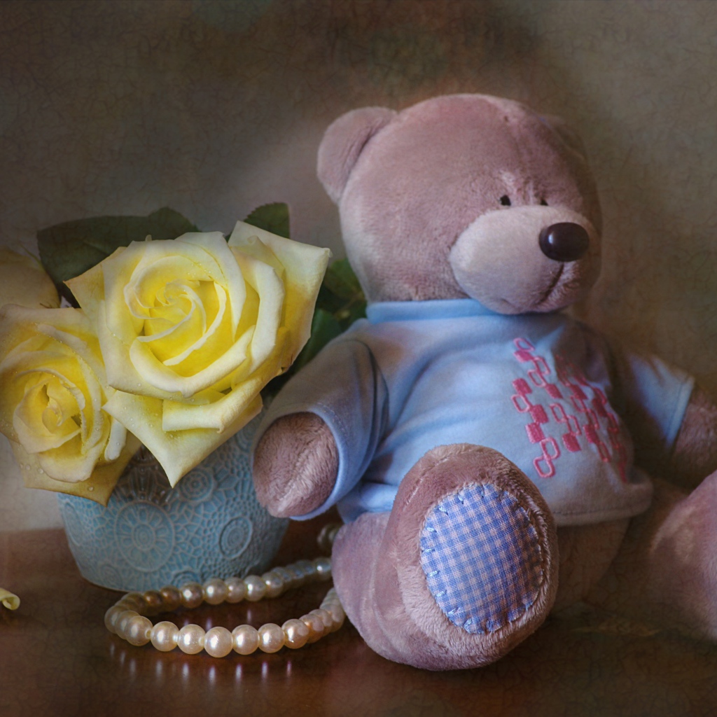 Big teddy bear with a bouquet of yellow roses