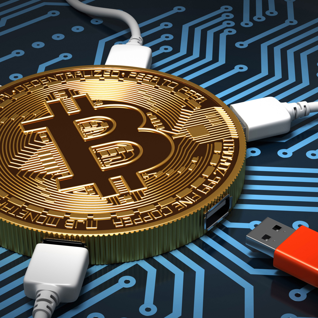 USB cable connected to bitcoin coin