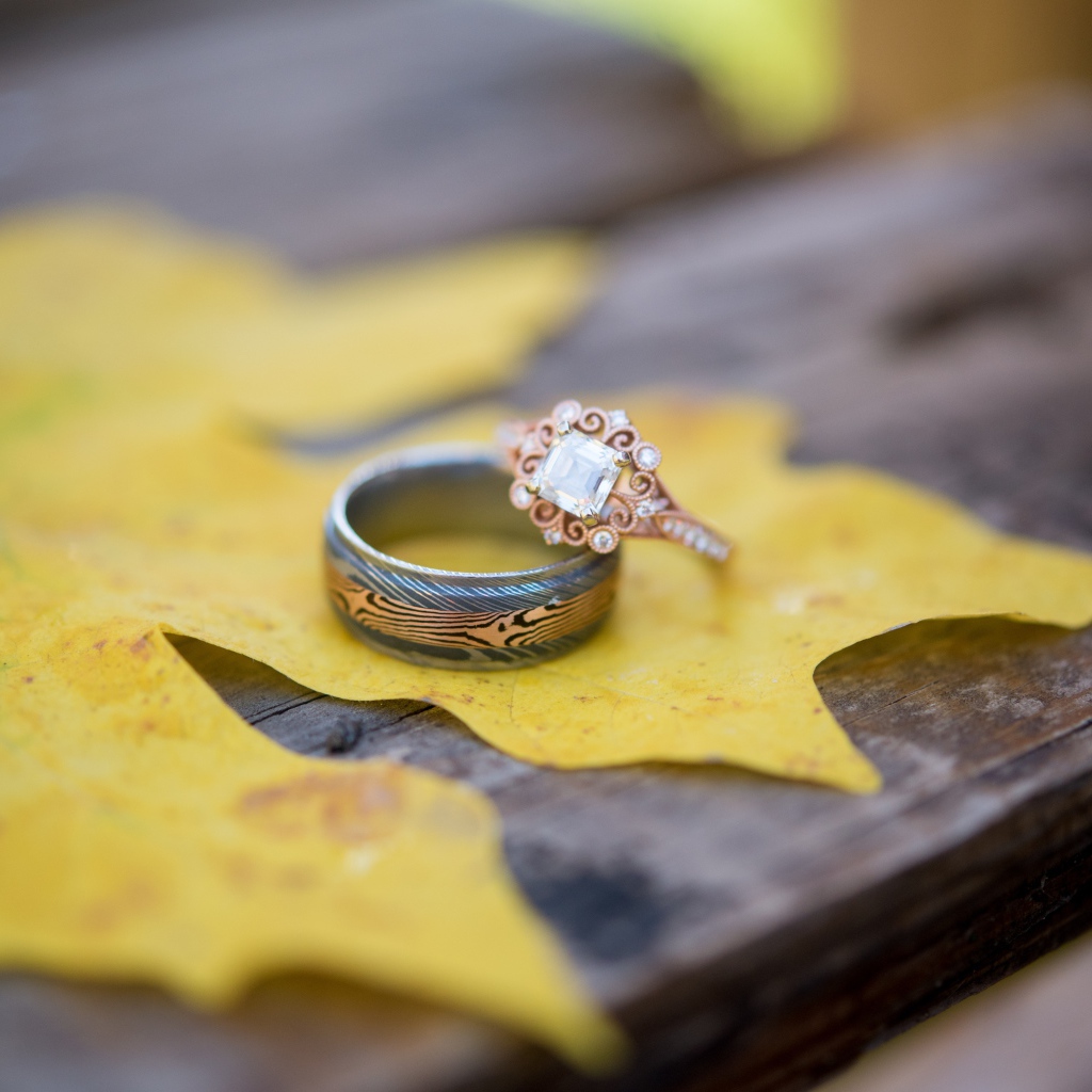 Gold rings with yellow leaf on the table