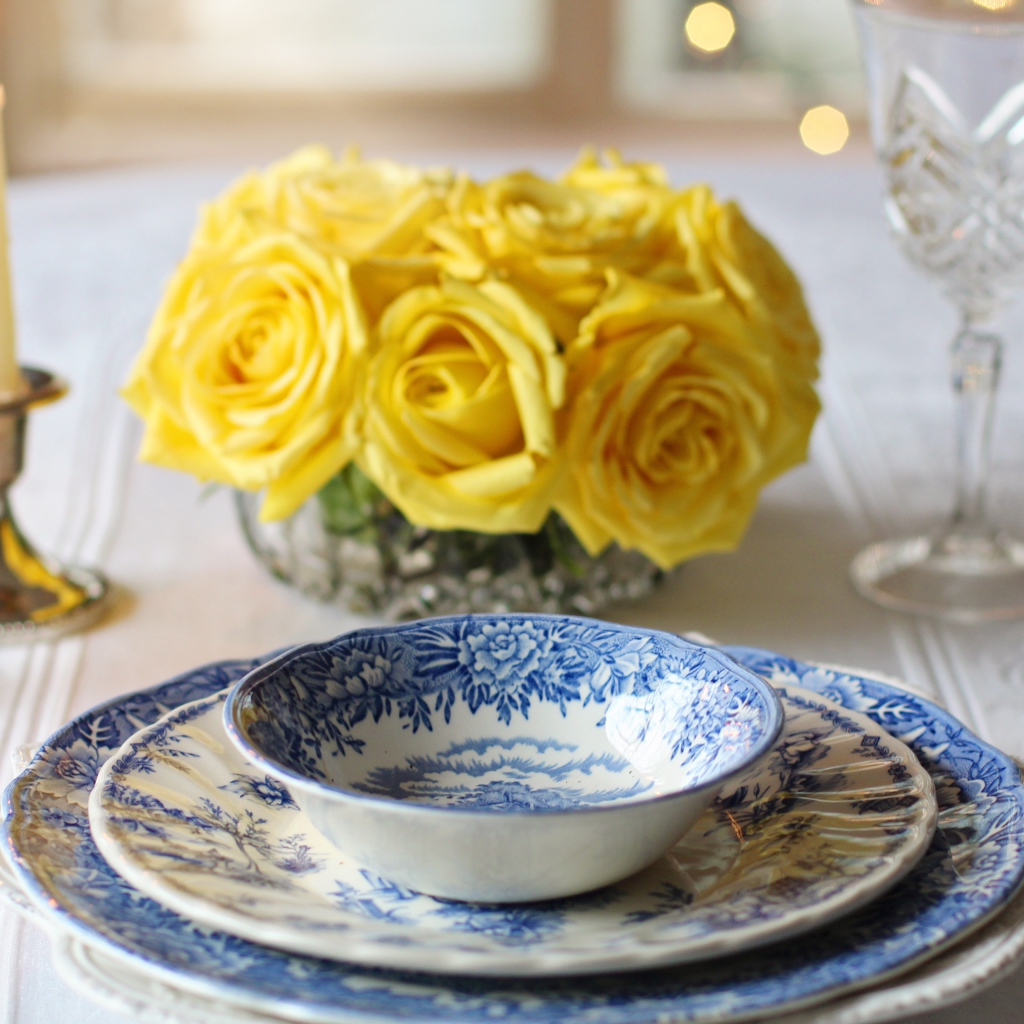 Beautiful dishes on the table with a bouquet of roses and candles