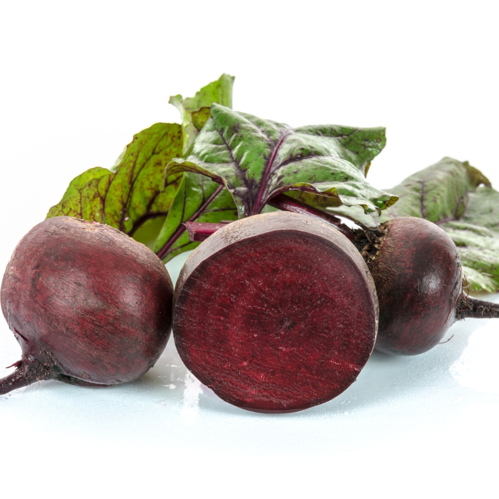 Beets with green leaves on a white background