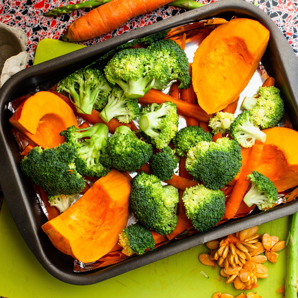 Свежие брокколи, морковь и тыква на противне 