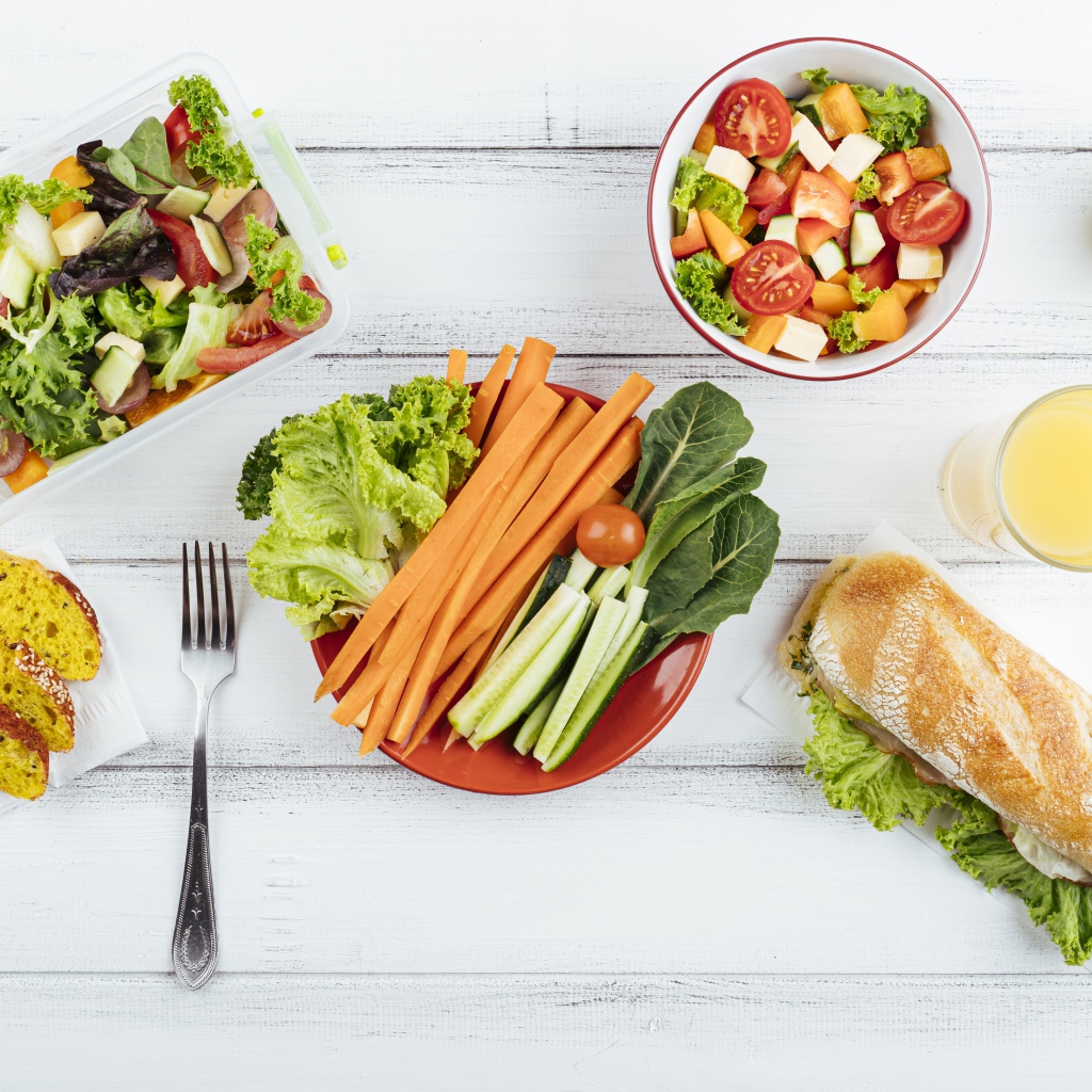 Салат из свежих овощей на столе с бутербродом 