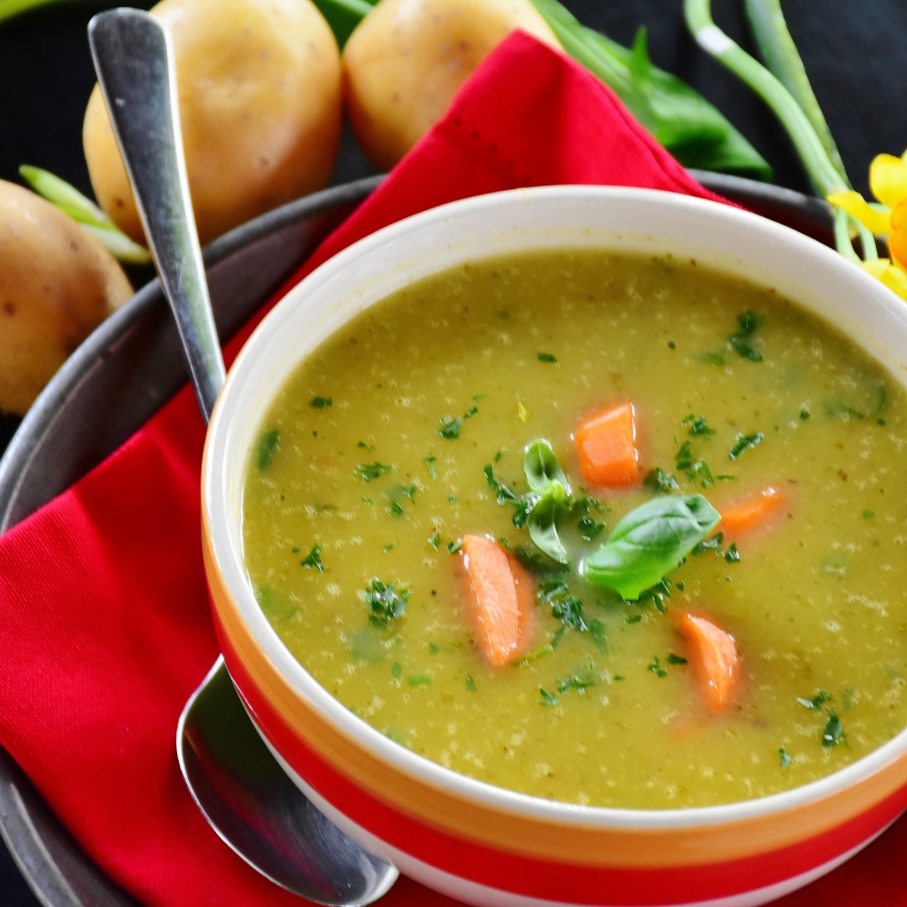 Puree pea soup on the table with potatoes
