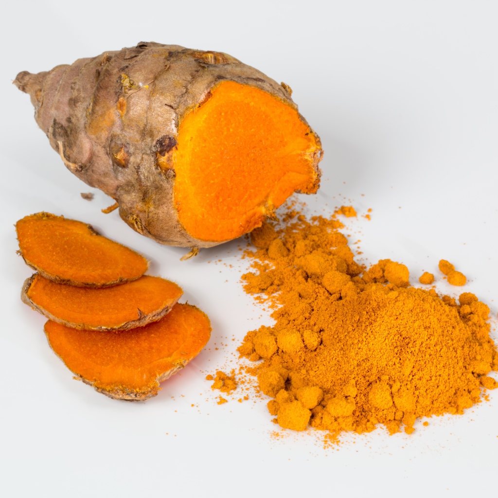 Turmeric root on gray background