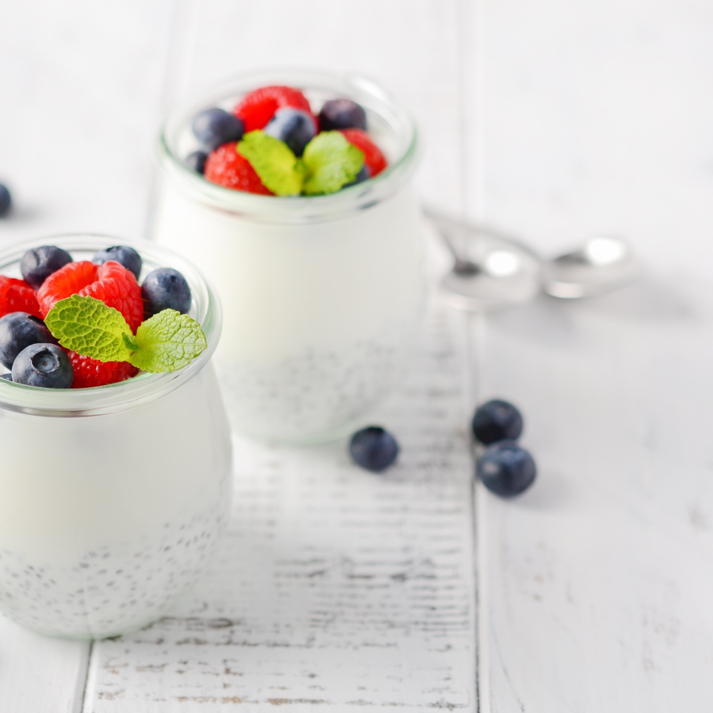 Yogurt in a jar with goji seeds and blueberries and raspberries