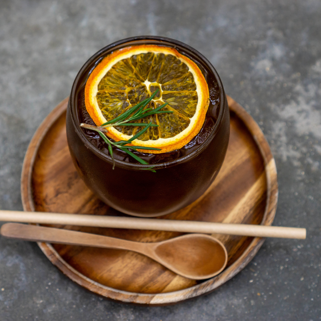 Cup of iced tea with ice and a slice of orange