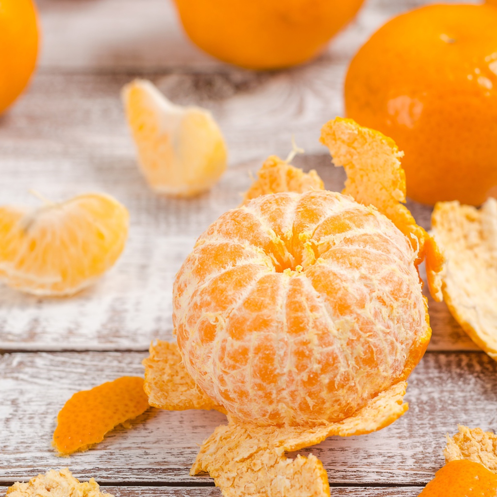 Очищенный мандарин на деревянном столе 