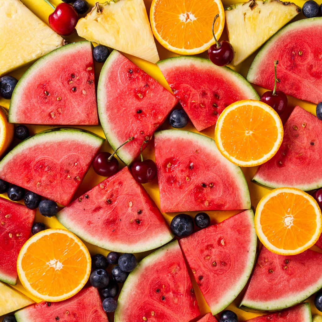 Вкусные свежие фрукты на желтом столе 