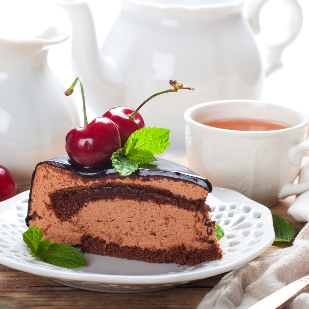 Торт с суфле в шоколаде с ягодами черешни на столе с чаем