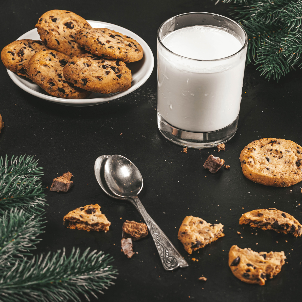 Cookies on a table with milk and spruce branches