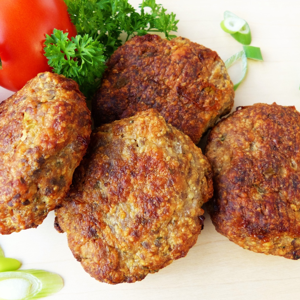 Appetizing cutlets on a plate with tomatoes and parsley