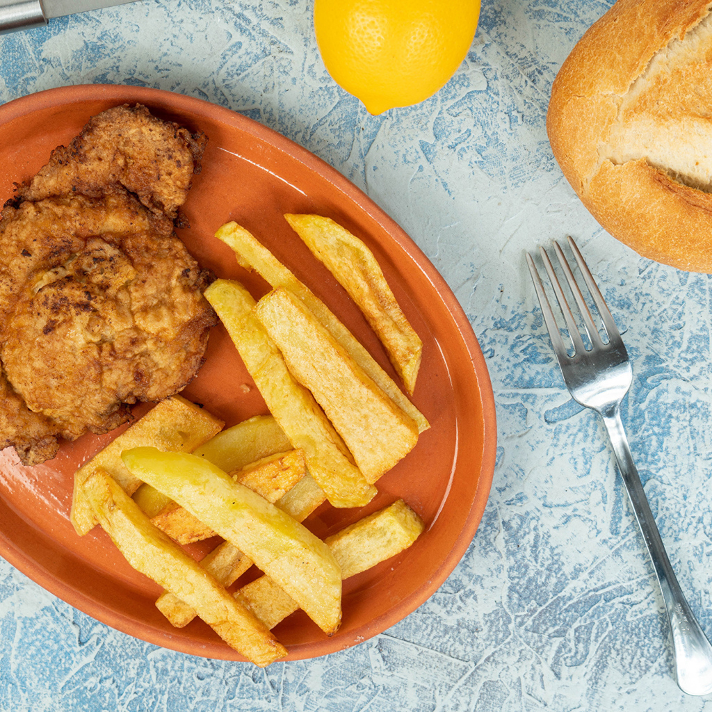 Отбивная с картофелем фри на тарелке 