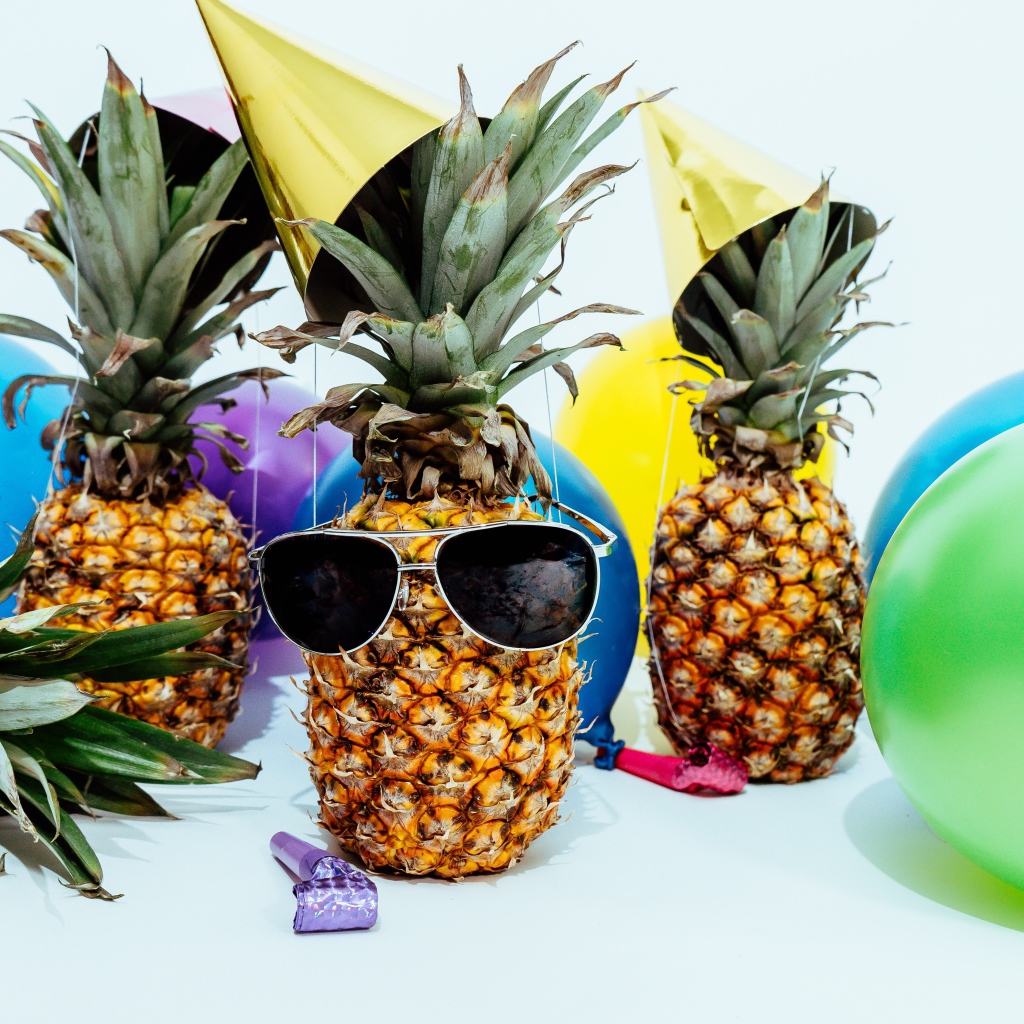 Pineapples in glasses with balloons