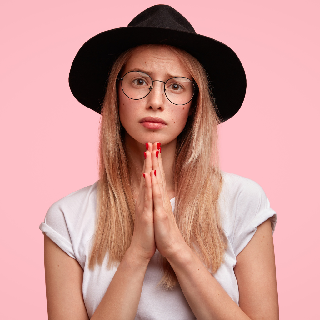 Девушка в черной шляпе умоляет о прощении 