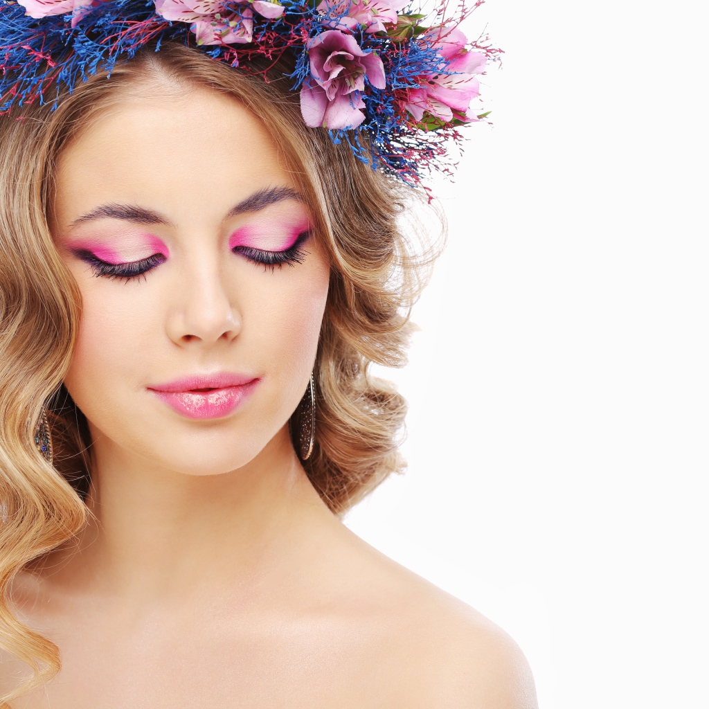 Girl model with closed eyes with pink make-up on a white background.