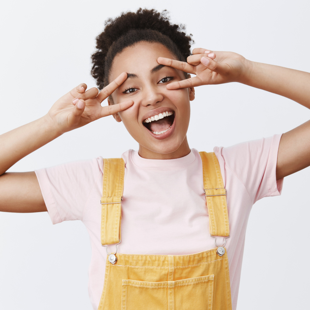 Счастливая девушка с руками у лица 