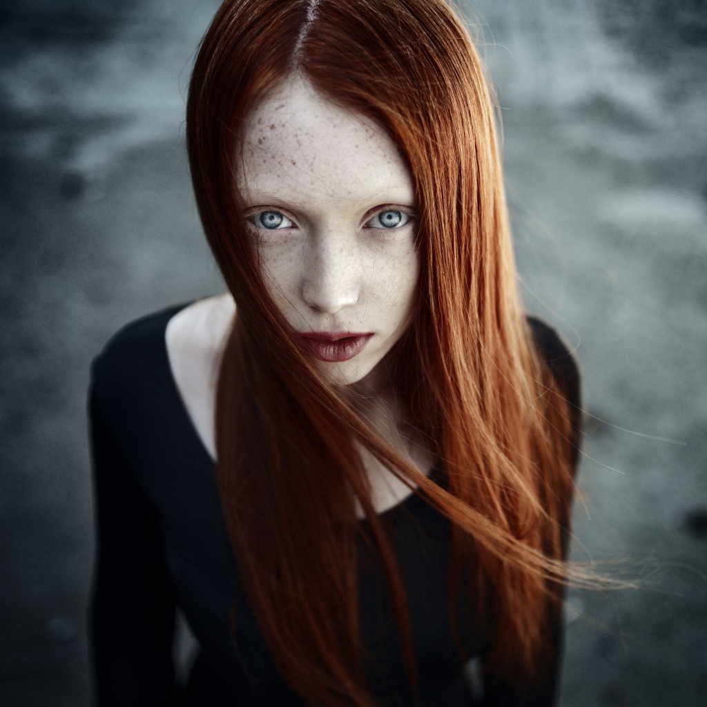 Рыжая длинноволосая девушка с веснушками на лице