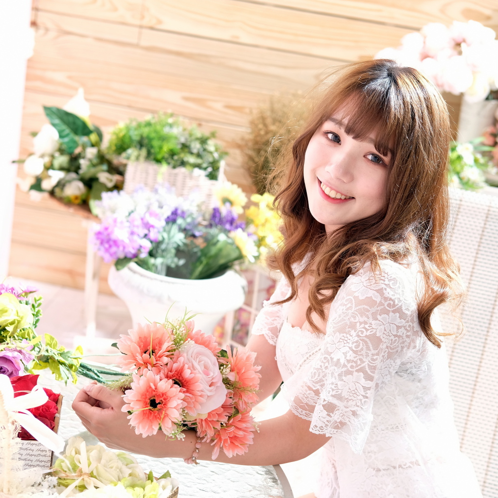 Улыбающаяся девушка азиатка в белом кружевном платье 