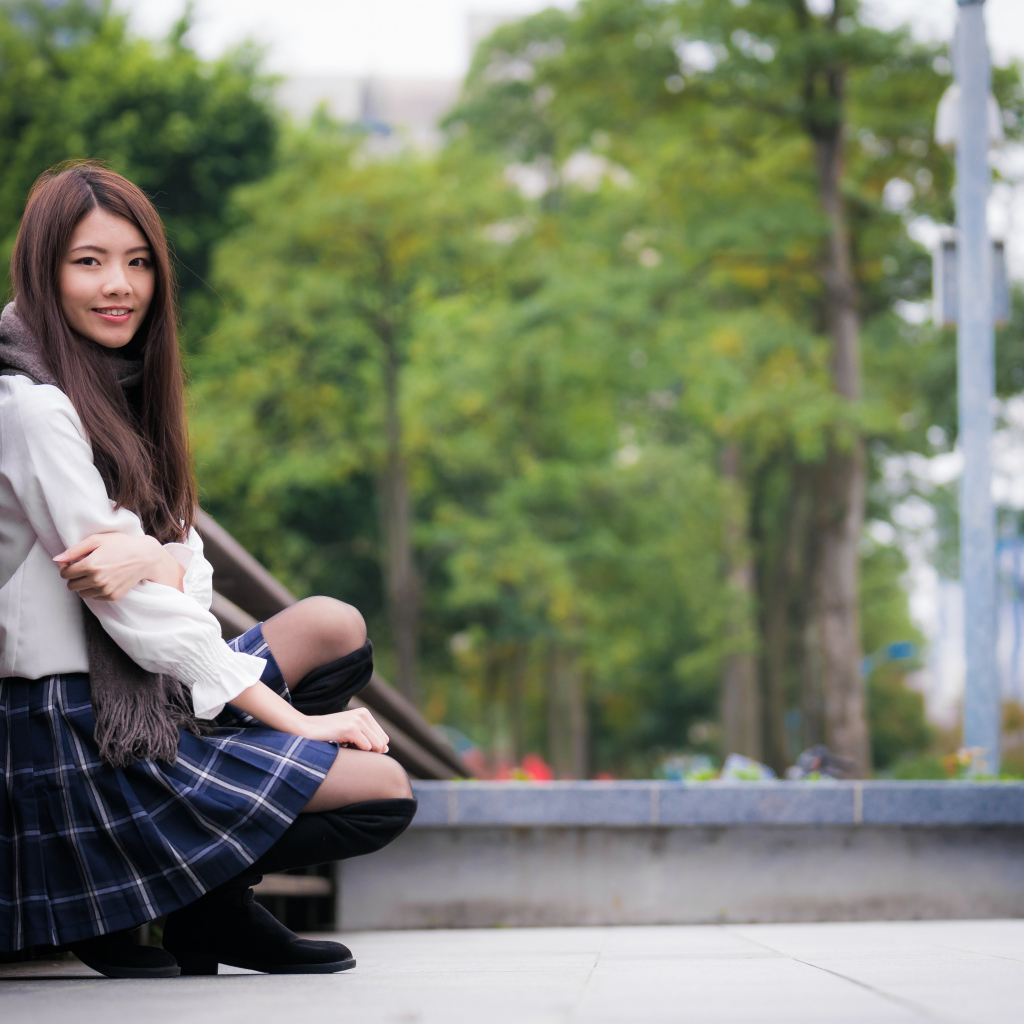 Молодая девушка азиатка в черных сапогах