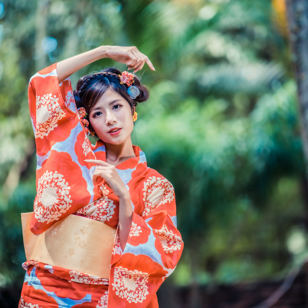 Молодая азиатка в кимоно в парке 