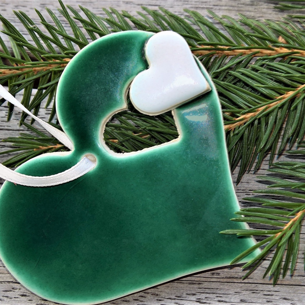 Green heart with fir branch on the table
