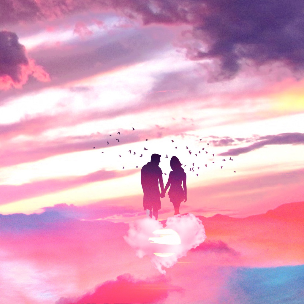 Silhouette of a couple in love on a cloud in the shape of a heart in the sky