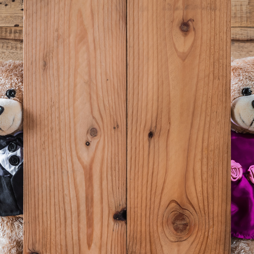 Два плюшевых медведя с сердечками у стены