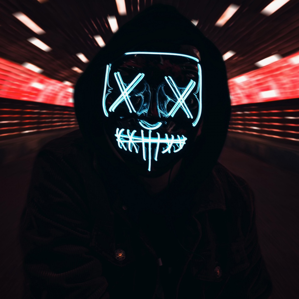 The guy in the black jacket in the neon mask of anonymous on his face