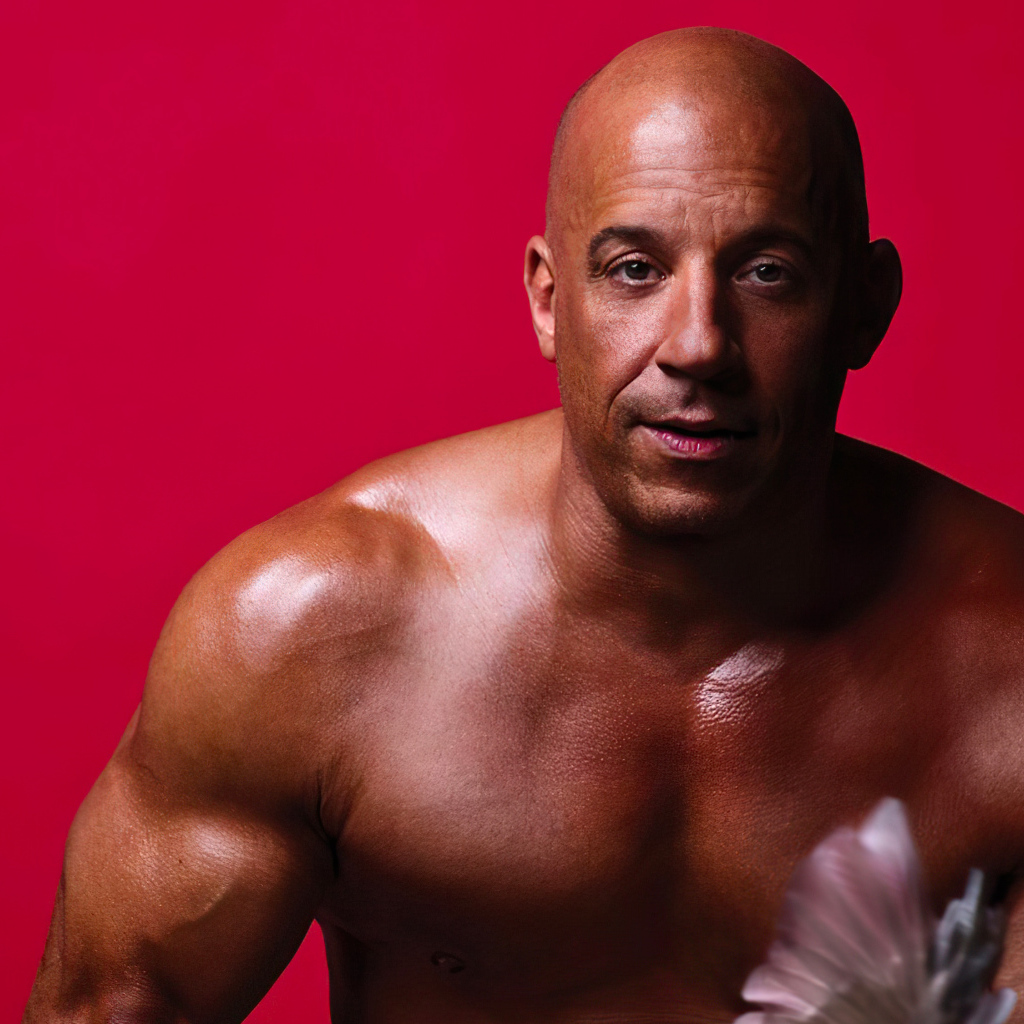 Pumped up actor Vin Diesel on a red background