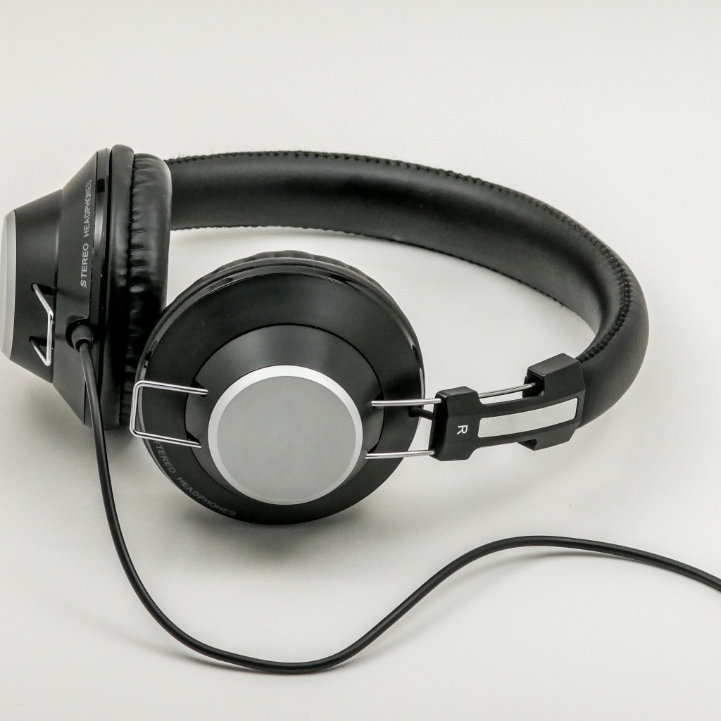 Big black headphones on gray background