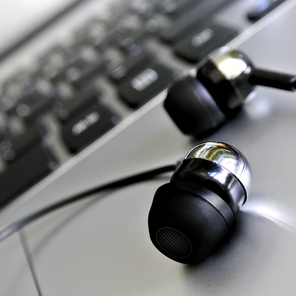 Headphones lie near the keyboard close-up