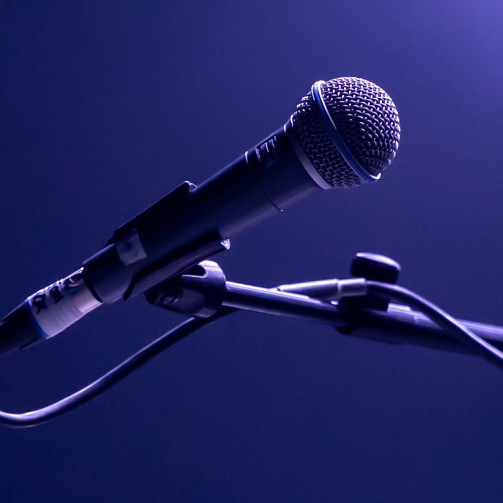 Микрофон на стойке на синем фоне