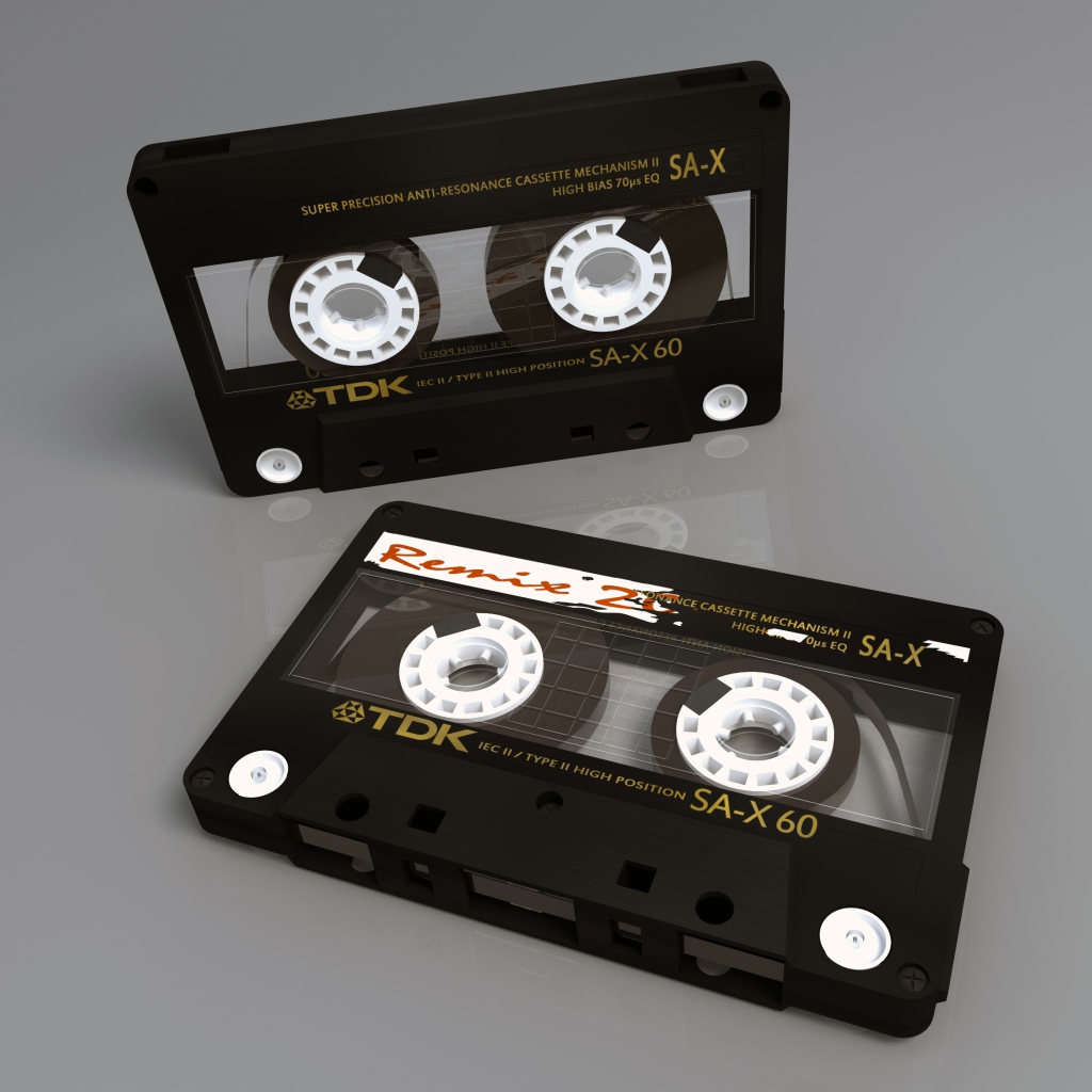 Две магнитофонные кассеты TDK на сером фоне