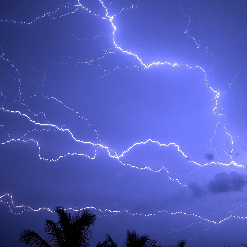 Bright lightning cuts through the sky during a tropical storm