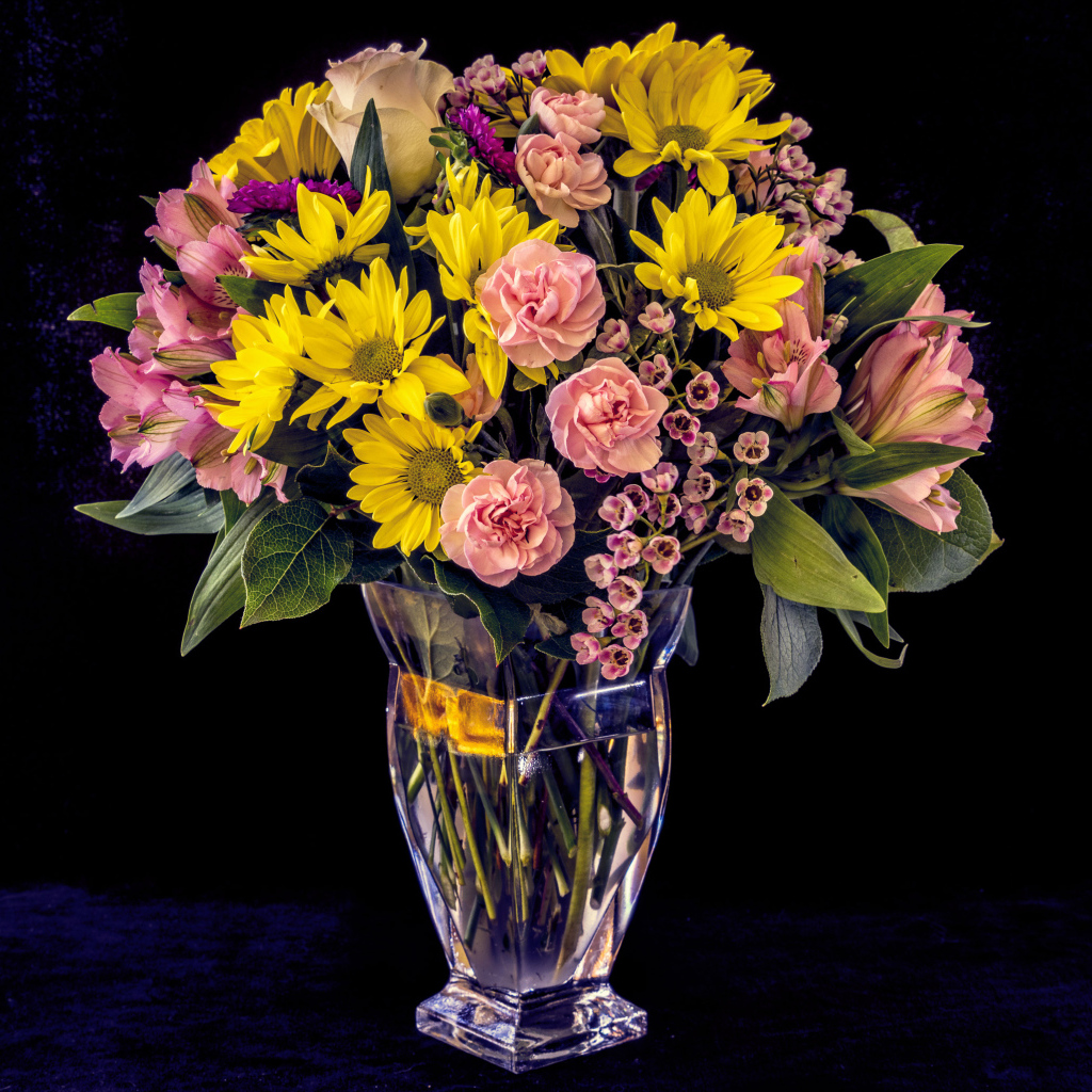 Букет красивых разноцветных цветов в вазе на черном фоне