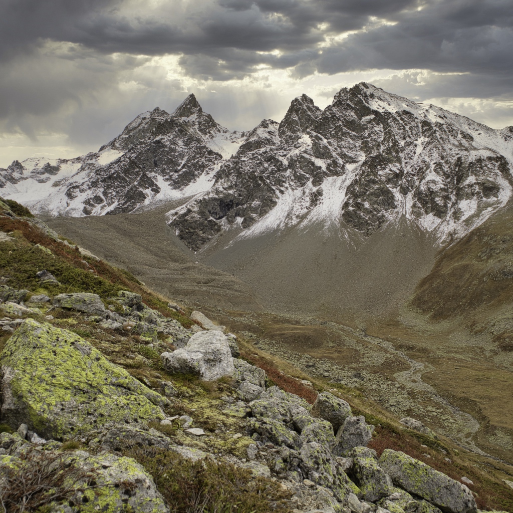 Высохшая река в горах под грозовым небом