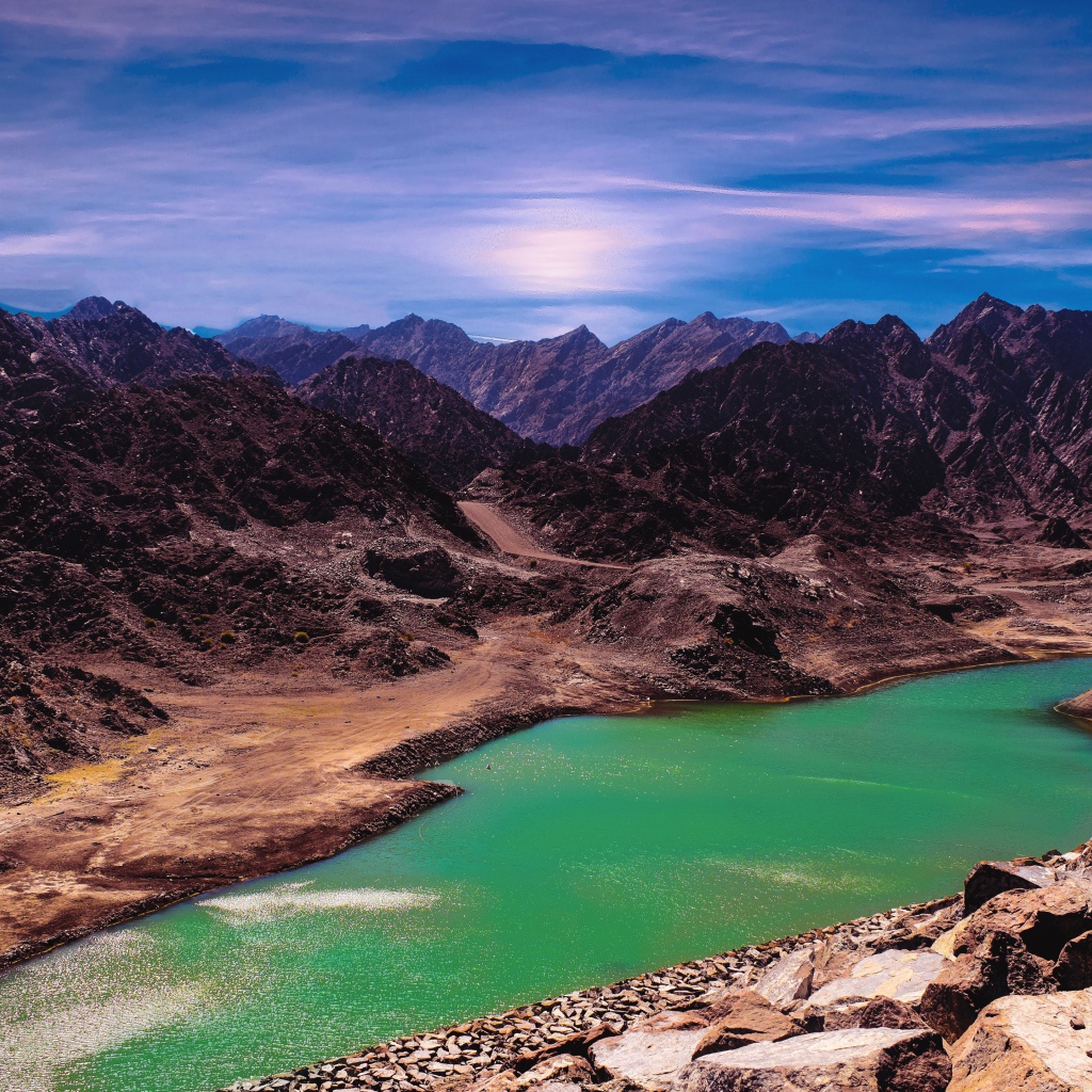 Река между высоких гор под голубым небом 