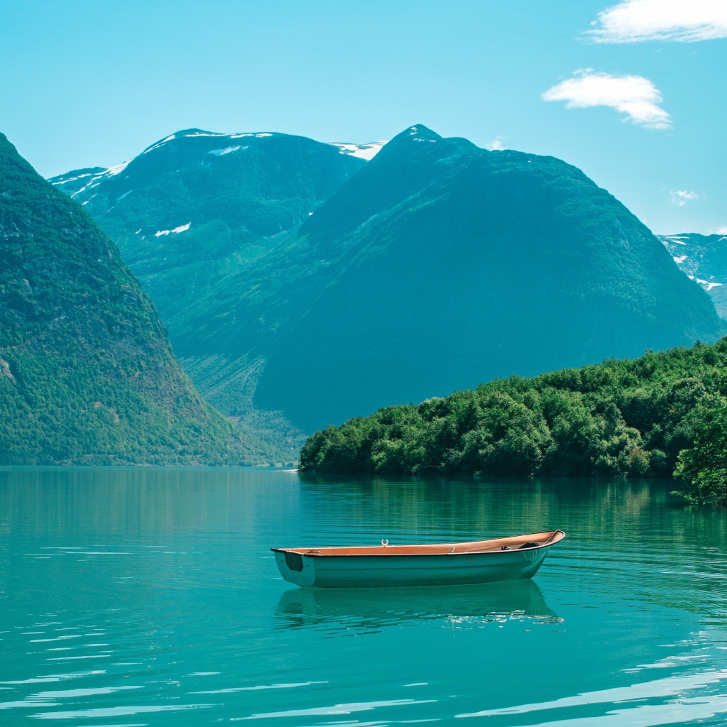 Boat on the blue water of a lake in the mountains