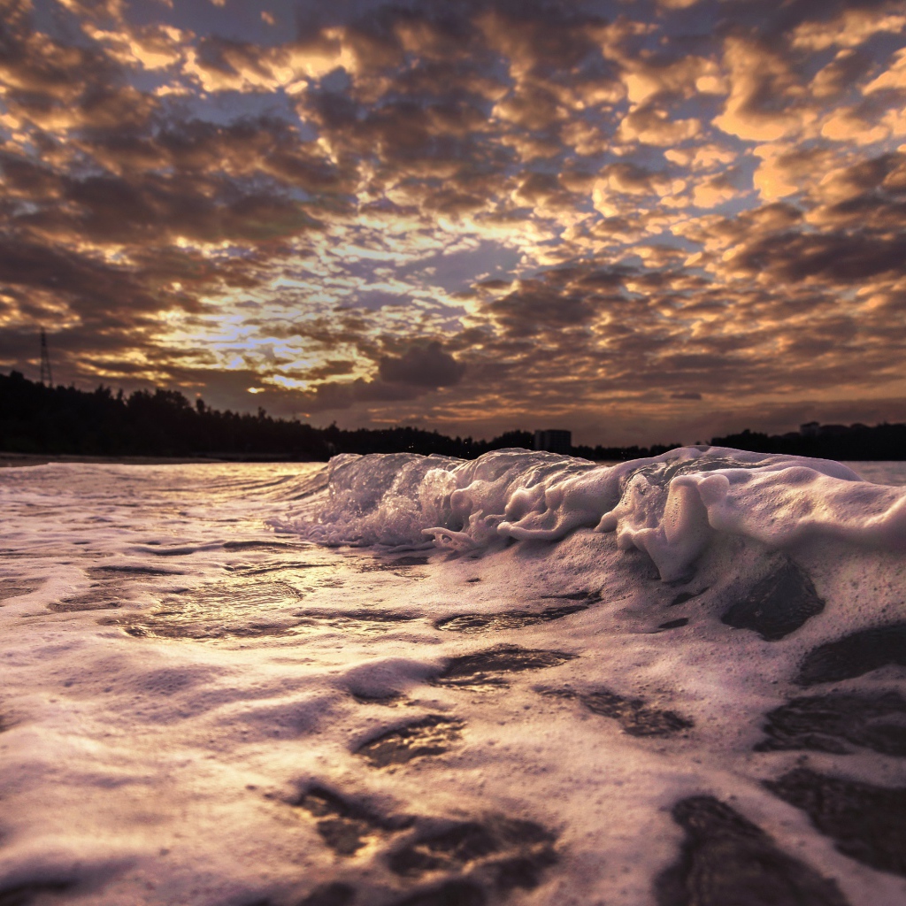 White waves in the sand at sunrise