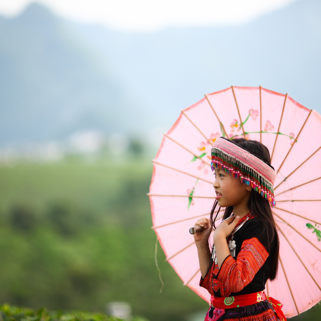 Маленькая девочка азиатка в розовым зонтом
