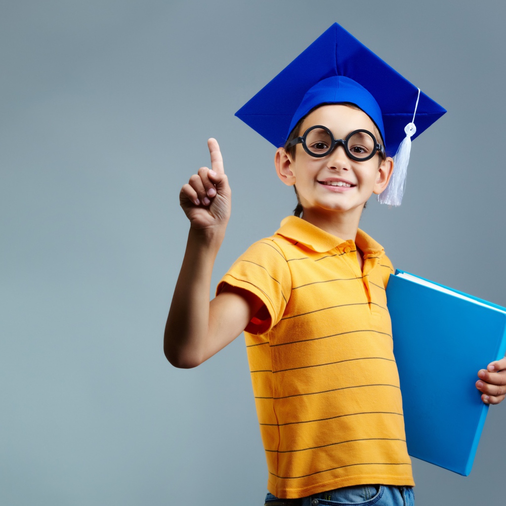 Маленький ученый мальчик с книгой в руке 