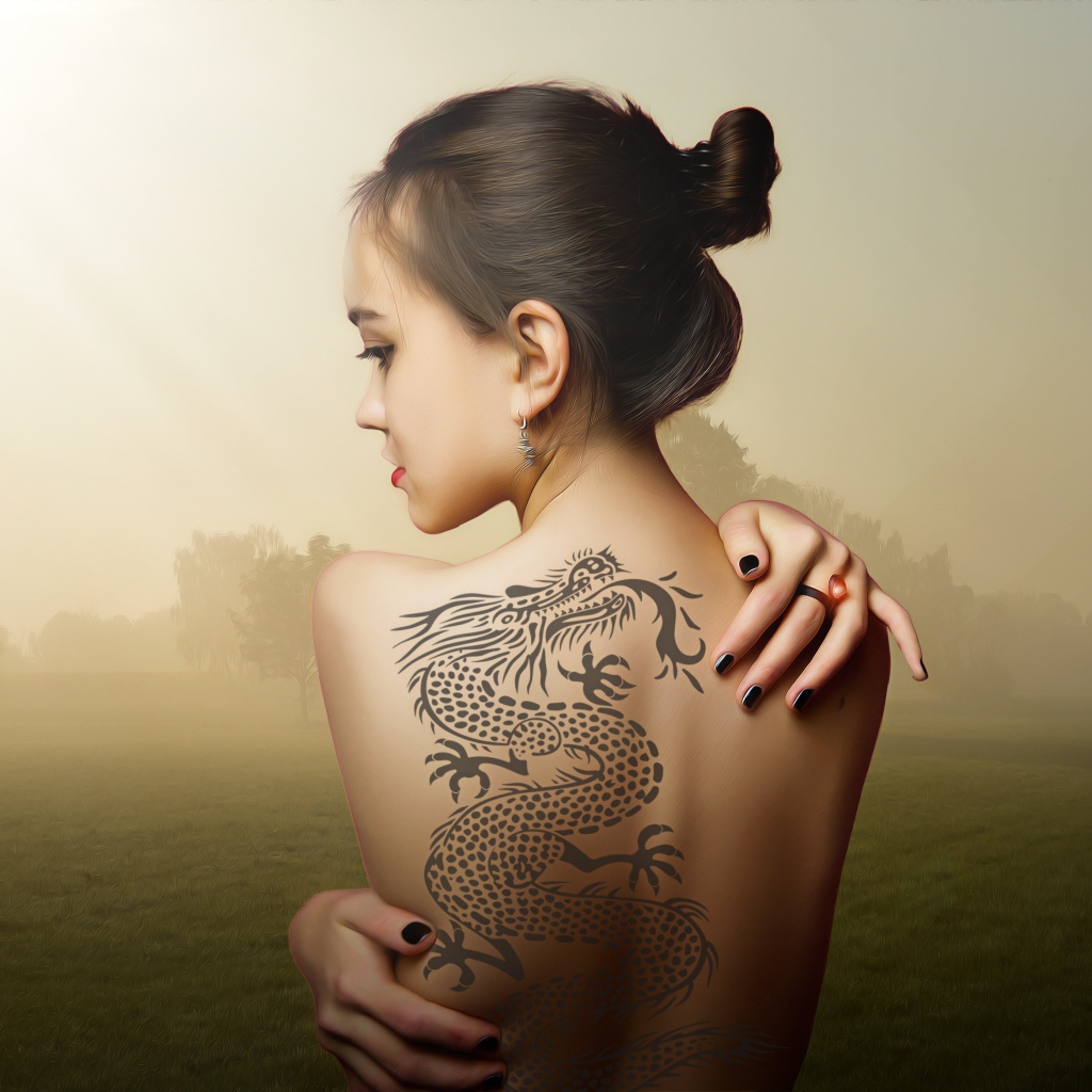 Beautiful girl with a dragon tattoo on her back