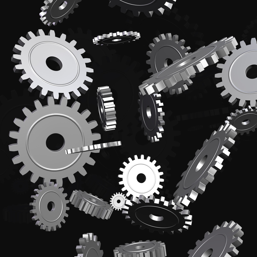 Металлические шестеренки в воздухе на черном фоне