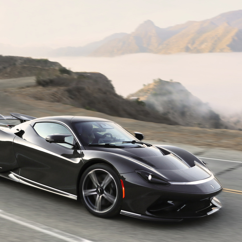 Черный спортивный автомобиль Pininfarina Battista,  2022 года на трассе