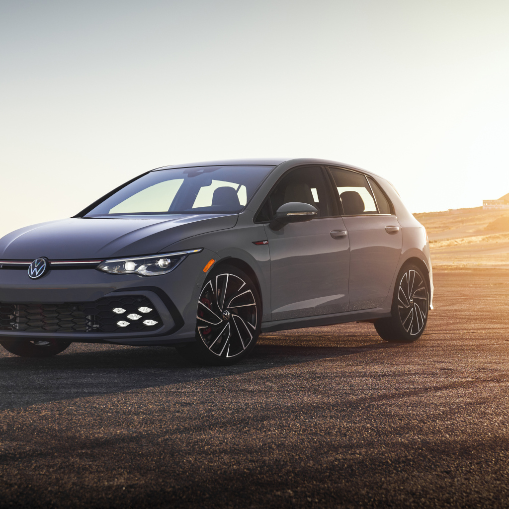 Серебристый автомобиль Volkswagen Golf GTI на фоне заката