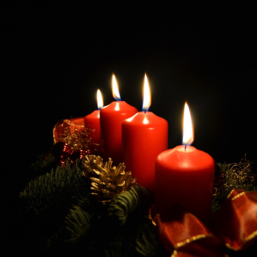 Red holiday candles on black background