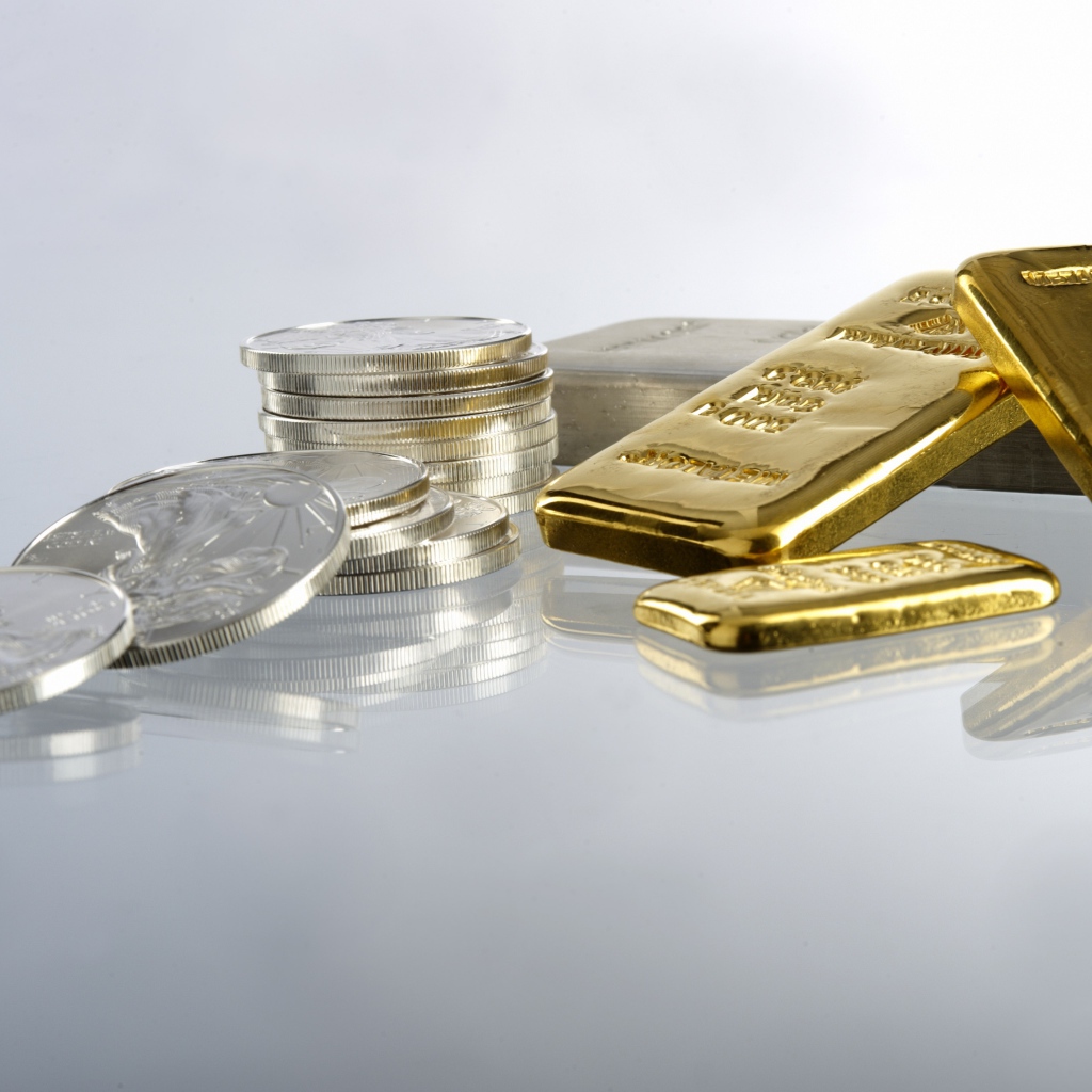 Gold bars of gold and coins on a white background