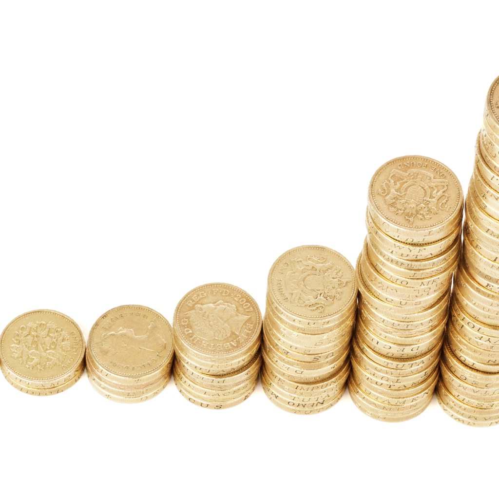Stacks of gold coins on a white background